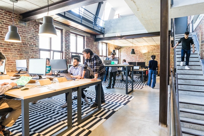 A shot of an active office with everyone at work