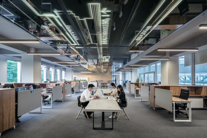 An aesthetic shot of an office with people hard at work.